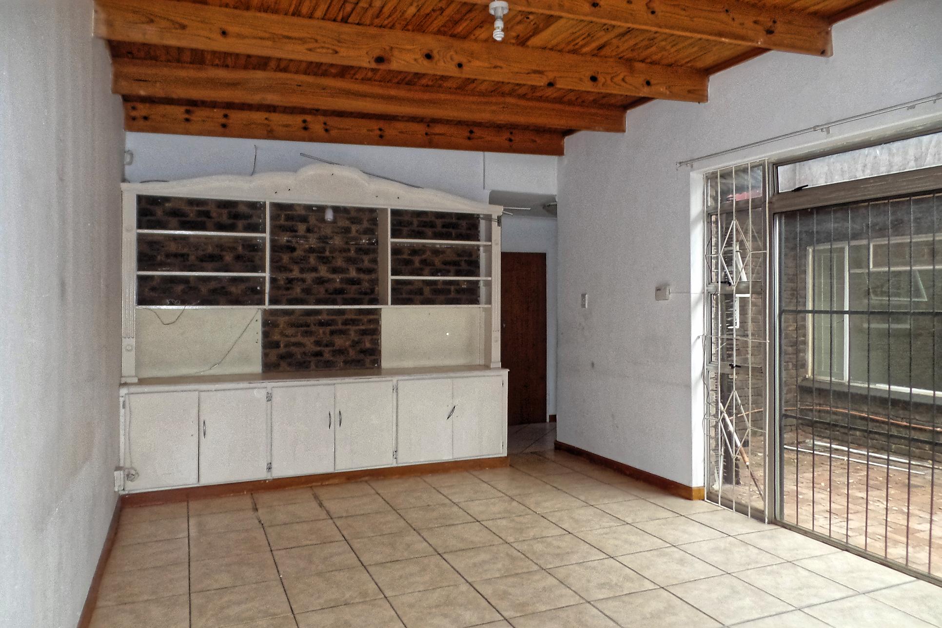 TV room with sliding door leading to the backyard