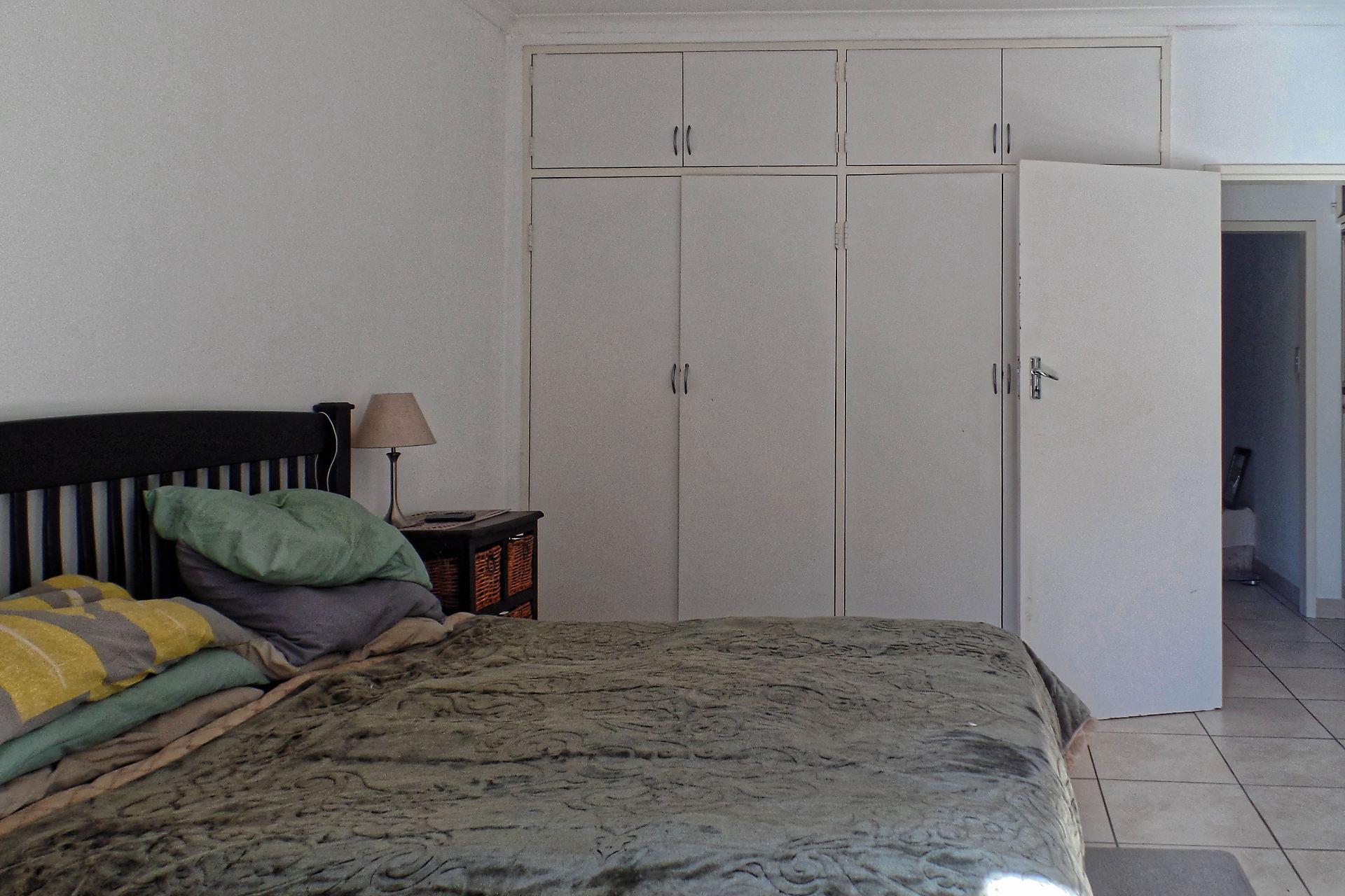 A large bedroom with queen size bed